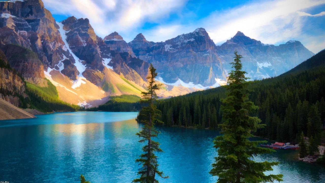 Turquoise glacial water at Moraine Lake beneath jagged peaks.