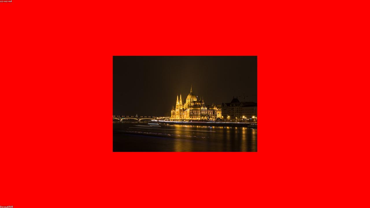 Budapest's parliament glowing across the Danube at dusk.