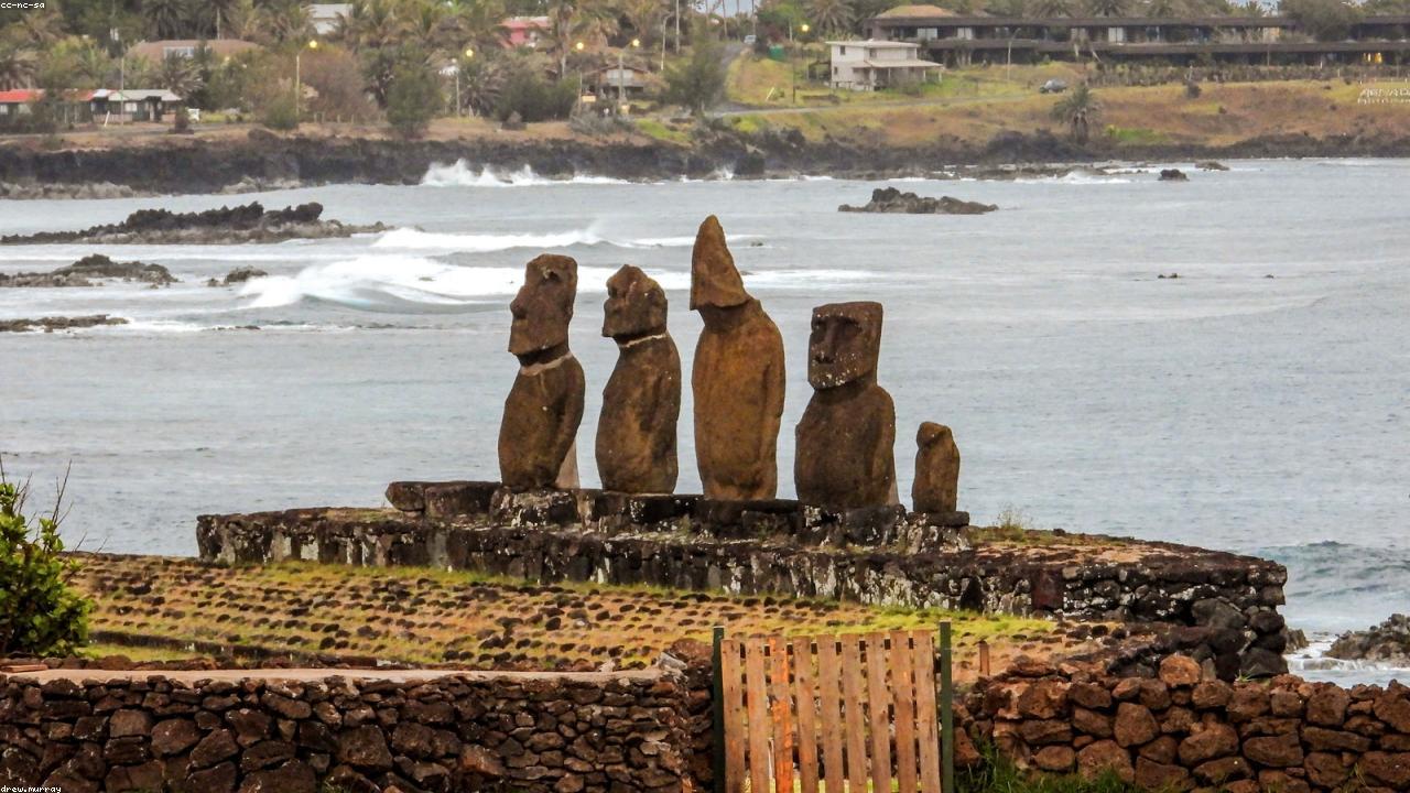 Moai stand silhouetted at sunset on Easter Island.