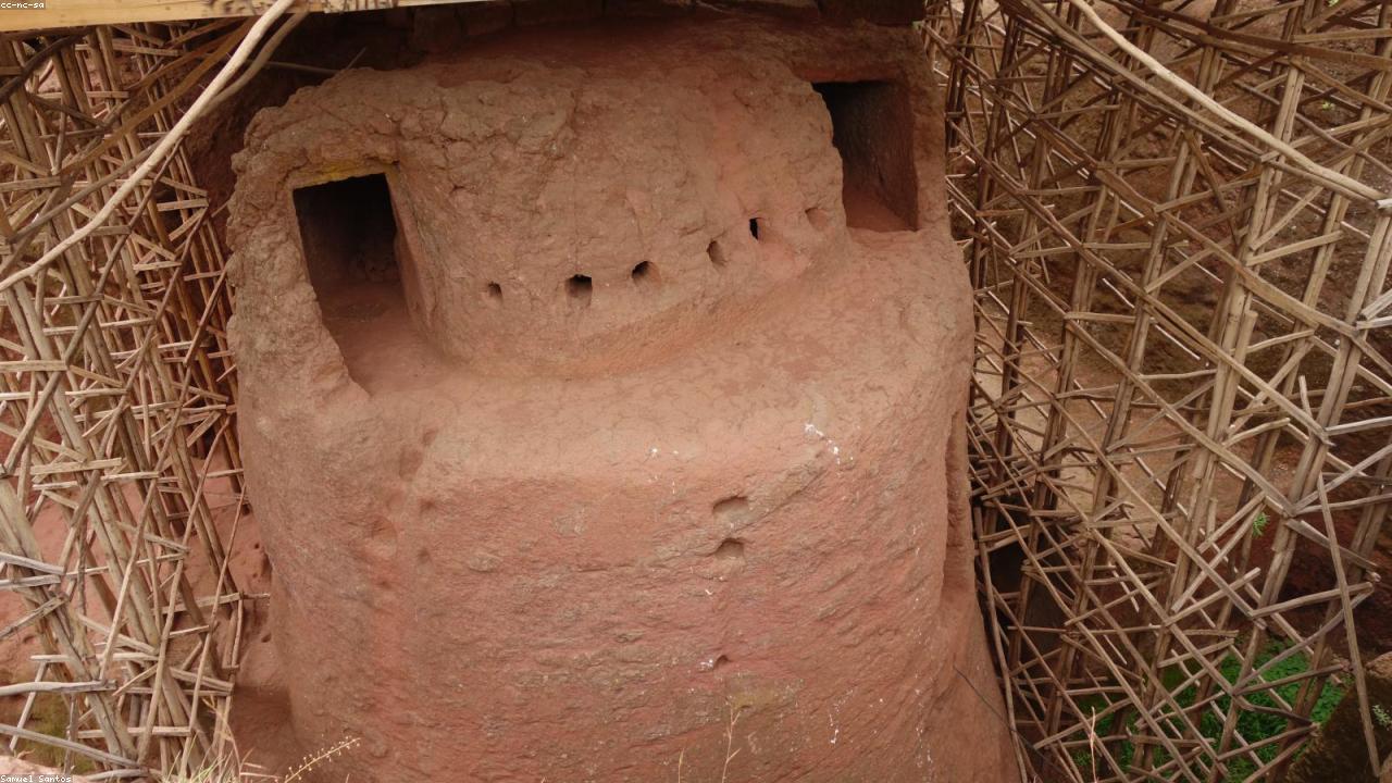White-robed priests at a rock-hewn church entrance in Lalibela.