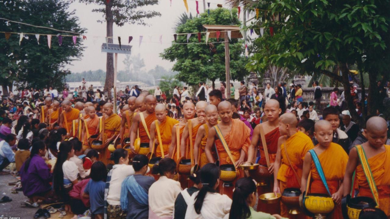 Saffron-robed monks walk the morning alms route in Luang Prabang.