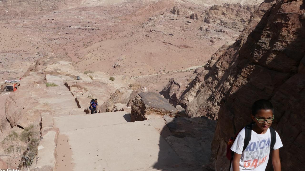 Petra's rose-red Treasury façade seen through the slot canyon.