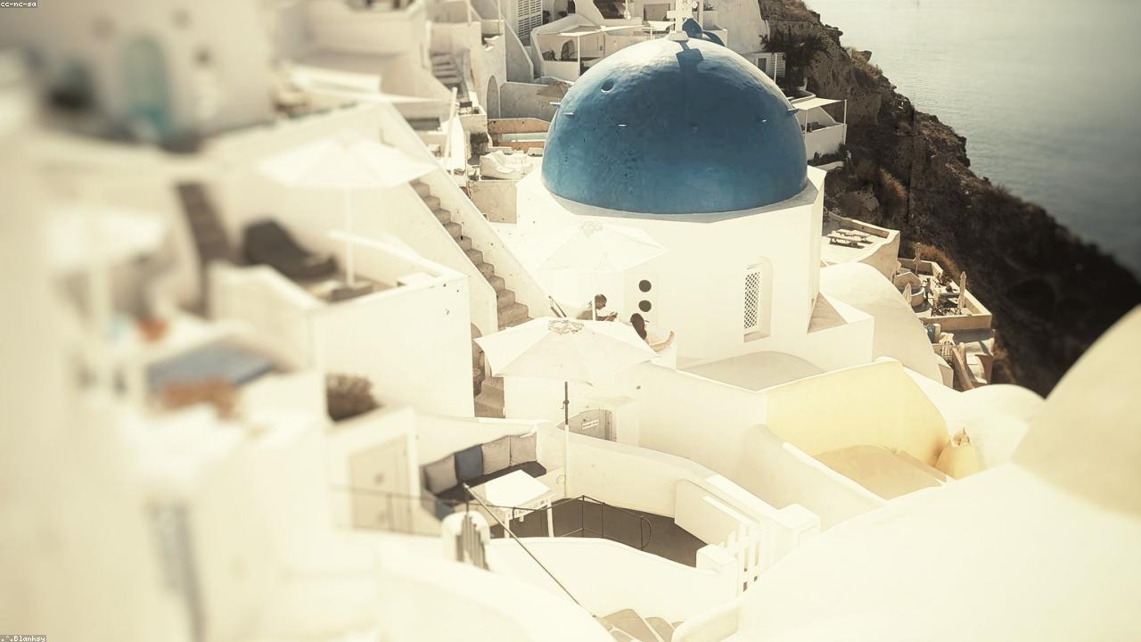 Whitewashed Cycladic houses on Santorini's caldera rim.