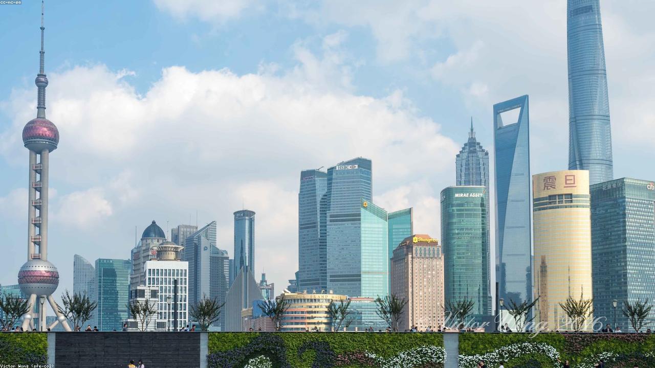Pudong's neon skyline reflects in the Huangpu River.