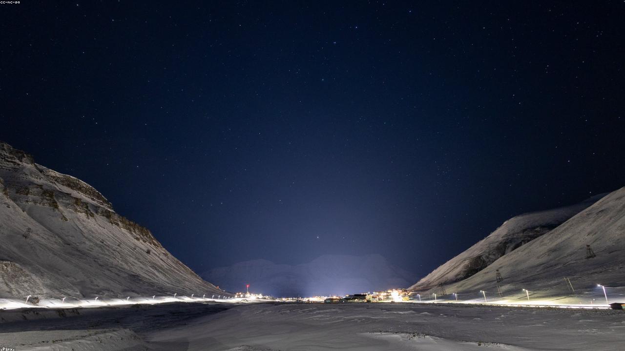 Coloured wooden houses of Longyearbyen below Arctic mountains.