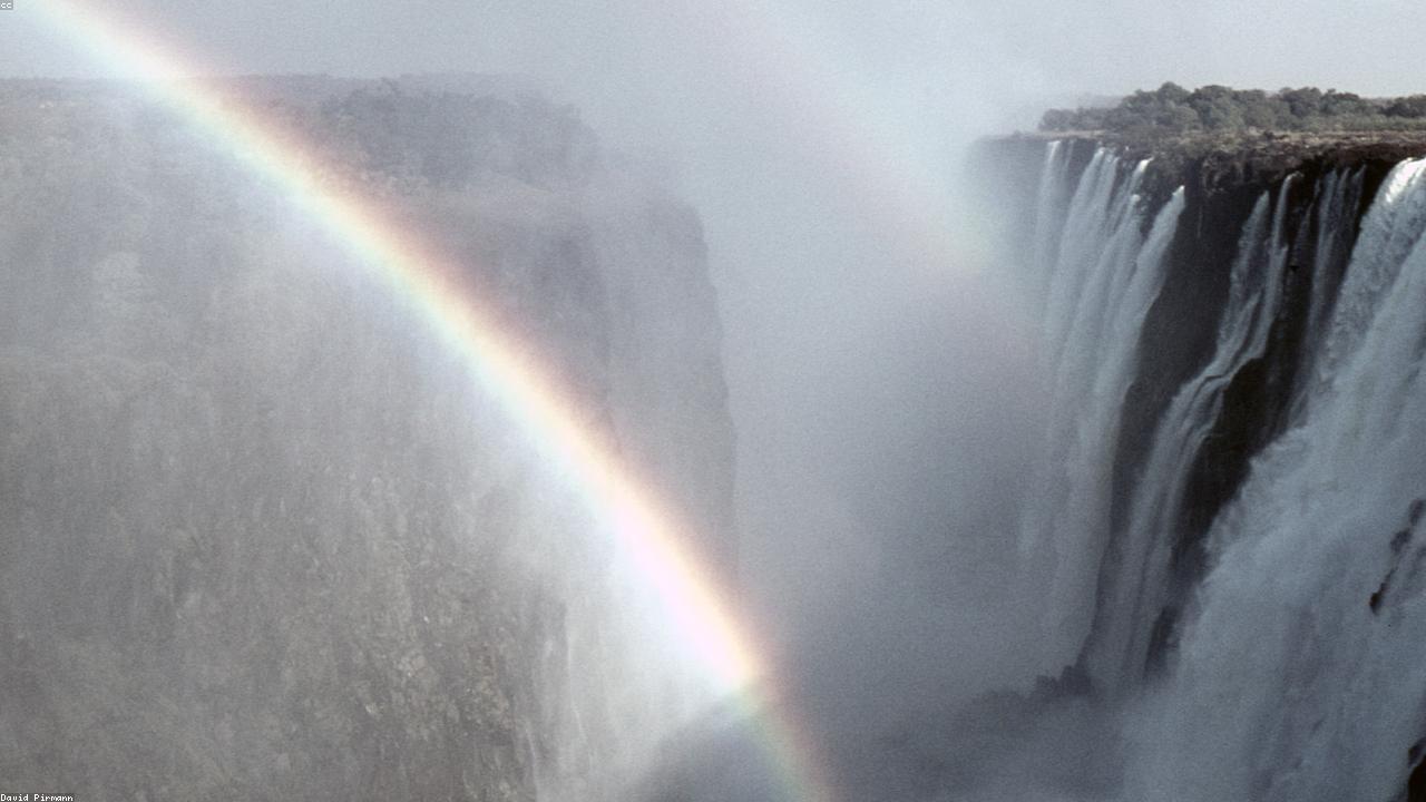 Spray rises from the wide curtain of Victoria Falls on the Zambezi.