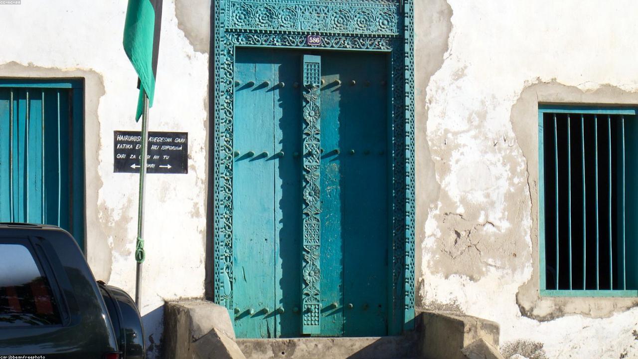 Carved wooden doors and ochre walls in Stone Town, Zanzibar.